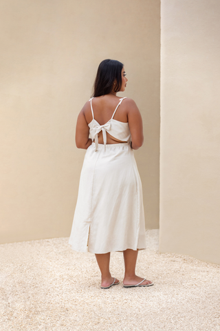 Rawbought Terra Linen Midi Tie-Back Dress featuring tie-back detail, elasticated waistband, and panelled seams, fully lined and made from soft linen blend, available in sizes XS to XXXL in monochromatic colours Coal and Sand.