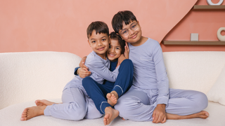 Sibling trio wearing matching Je Dors Lounge Sets, playing together