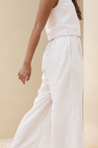 Rawbought Terra Wide Leg Trousers with high waist and flowing silhouette, featuring zipper, elasticated back, and pockets, crafted from soft linen blend, available in sizes XS to XXXL in Coal and Sand.