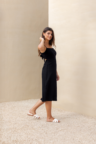 Rawbought Terra Linen Midi Tie-Back Dress featuring tie-back detail, elasticated waistband, and panelled seams, fully lined and made from soft linen blend, available in sizes XS to XXXL in monochromatic colours Coal and Sand.