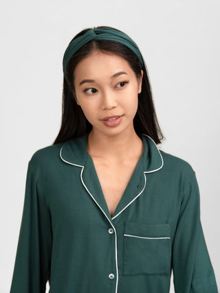 Woman wearing rawbought's  modal green pajama set with white piping