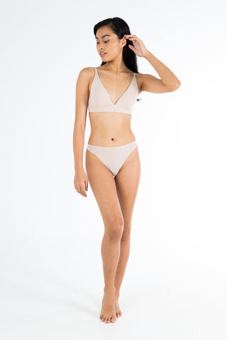 Rawbought Kiri lingerie collection, seamless and no-show nude thong. Melanie of Basic model posing from the front.